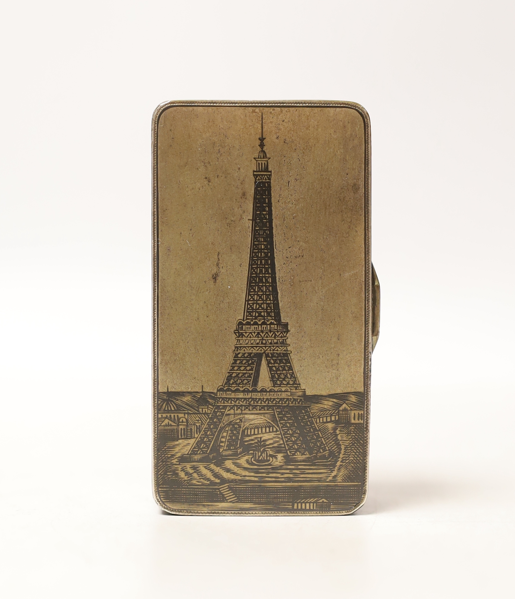 A late 19th century Russian 84 zolotnik and niello rectangular snuff box, the cover decorated with the Eiffel Tower, assay master Lev Oleks?, 1889, (hallmarked for the year the Eiffel Tower opened), 76mm